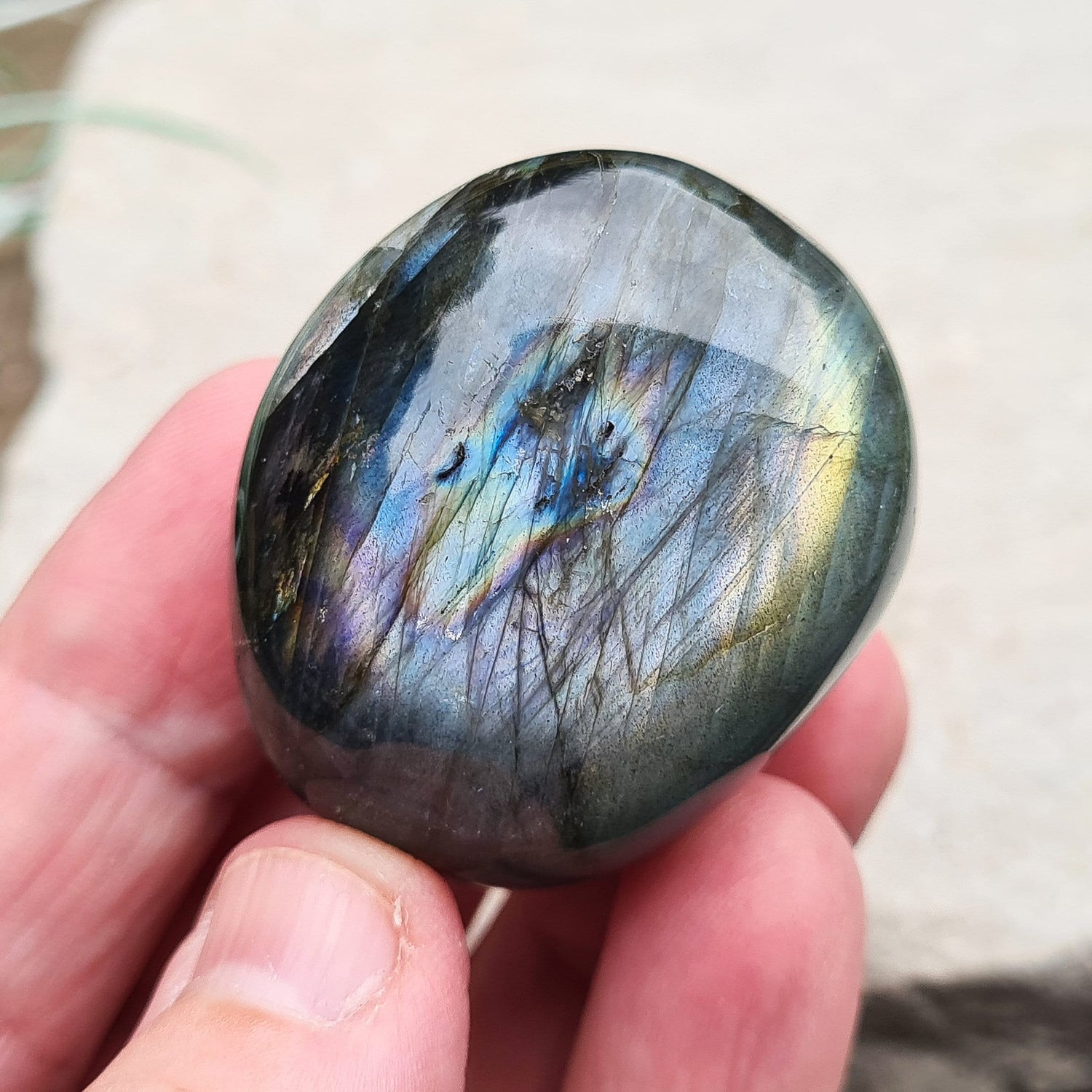 Polished Labradorite Crystal Pebble from Madagascar, also known as Spectrolite. Nice flashes of green, gold, and indigo blue colour in the light.