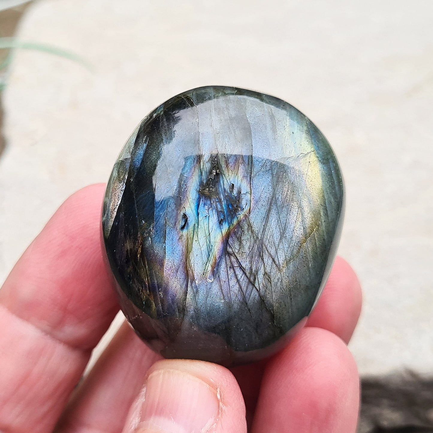 Polished Labradorite Crystal Pebble from Madagascar, also known as Spectrolite. Nice flashes of green, gold, and indigo blue colour in the light.