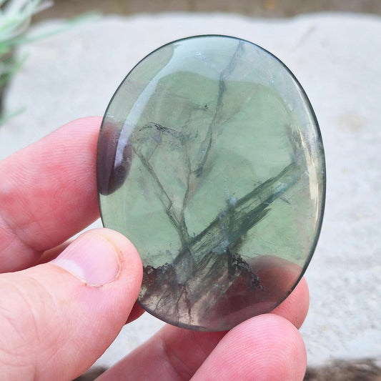 This lovely Fluorite crystal palm stone features a beautiful green color with a transparent quality. Sourced from China, it’s polished to fit comfortably in your hand.