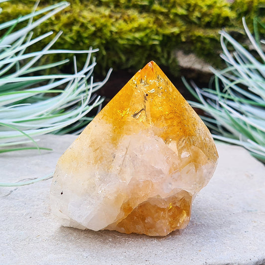 Citrine Crystal Standing Point. From Brazil. Wonderful golden orange colouring with light reflecting inclusions at the top. Tip is polished, base is cut flat and the rest is left natural.