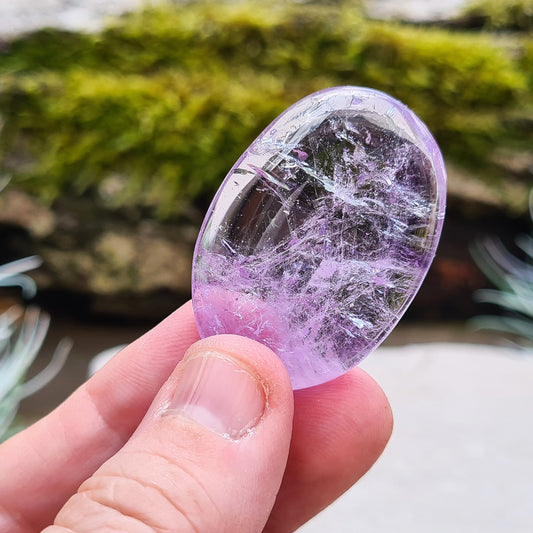 Translucent Amethyst Crystal Palm Stone, A Grade, from Brazil. Lovely quality palm stone which has light reflecting inclusions.

length - 4cm, width - 2.7 cm, depth - 0.80 cm