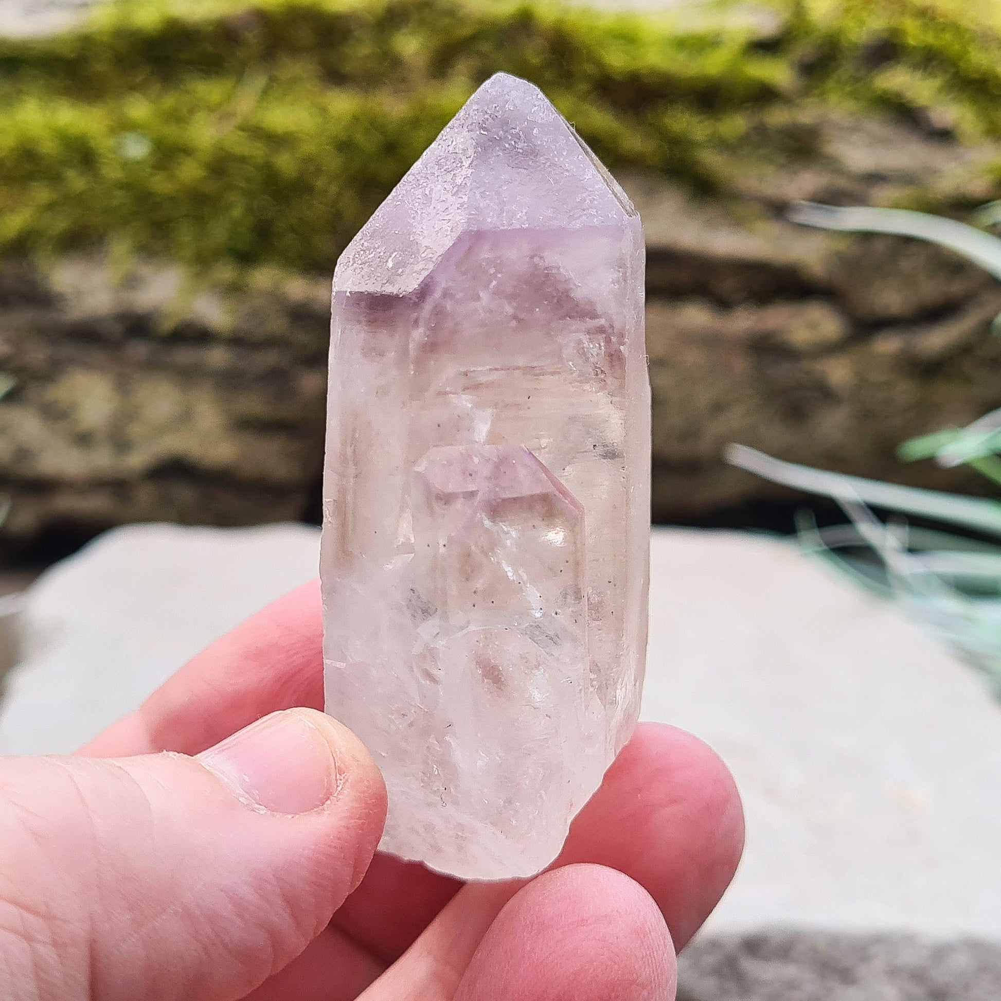 This natural Quartz and Amethyst crystal point from Madagascar features a clear Quartz base with a rich Amethyst tip. Known for its unique energy, this piece is both visually appealing and energetically powerful.