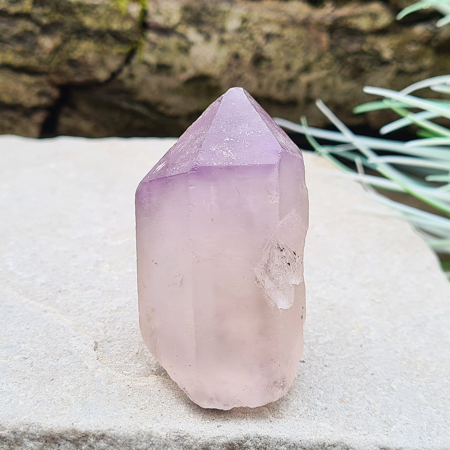 Madagascan Amethyst and Quartz Point. Natural. This point has a companion crystal aside it. Madagascan Amethyst and Quartz have a very different feel and energy to the Quartz and Amethyst that comes out of anywhere else. 