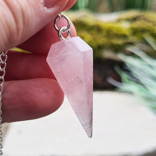 Rose Quartz Crystal Pendulum. comprises of a rose quartz crystal pendulum and a silver ring at the end of the chain. The pendulum will come in a box or pouch to keep it in. 