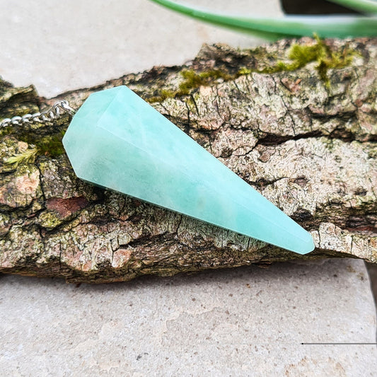 Amazonite Crystal Pendulum. Lovely pale green/blue colour. Chain has a clear bead on the end. Will come in a box or organza pouch.

length of crystal excluding chain - 3.6 cm