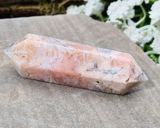 Pink Amethyst double terminated wand with generator tips, showcasing pink and white colors and patterns. It radiates and absorbs energy simultaneously, promoting balance.