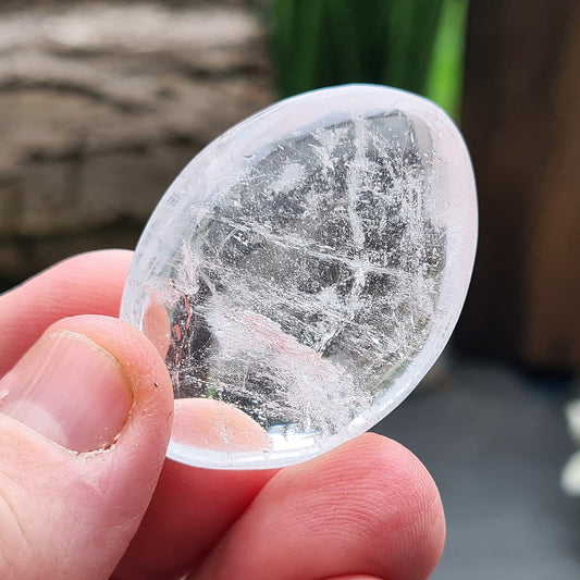 Quartz Crystal Palm Stone from Brazil. Nice sparkling light reflecting inclusions within it.