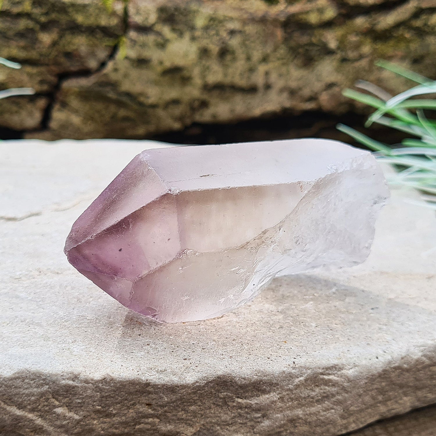 Madagascan Amethyst and Quartz Point. Natural. Once face has an Isis face, Madagascan Amethyst and Quartz have a very different feel and energy to the Quartz and Amethyst that comes out of anywhere else. This crystal is just gorgeous. It has a smokiness in the tip to it as well.