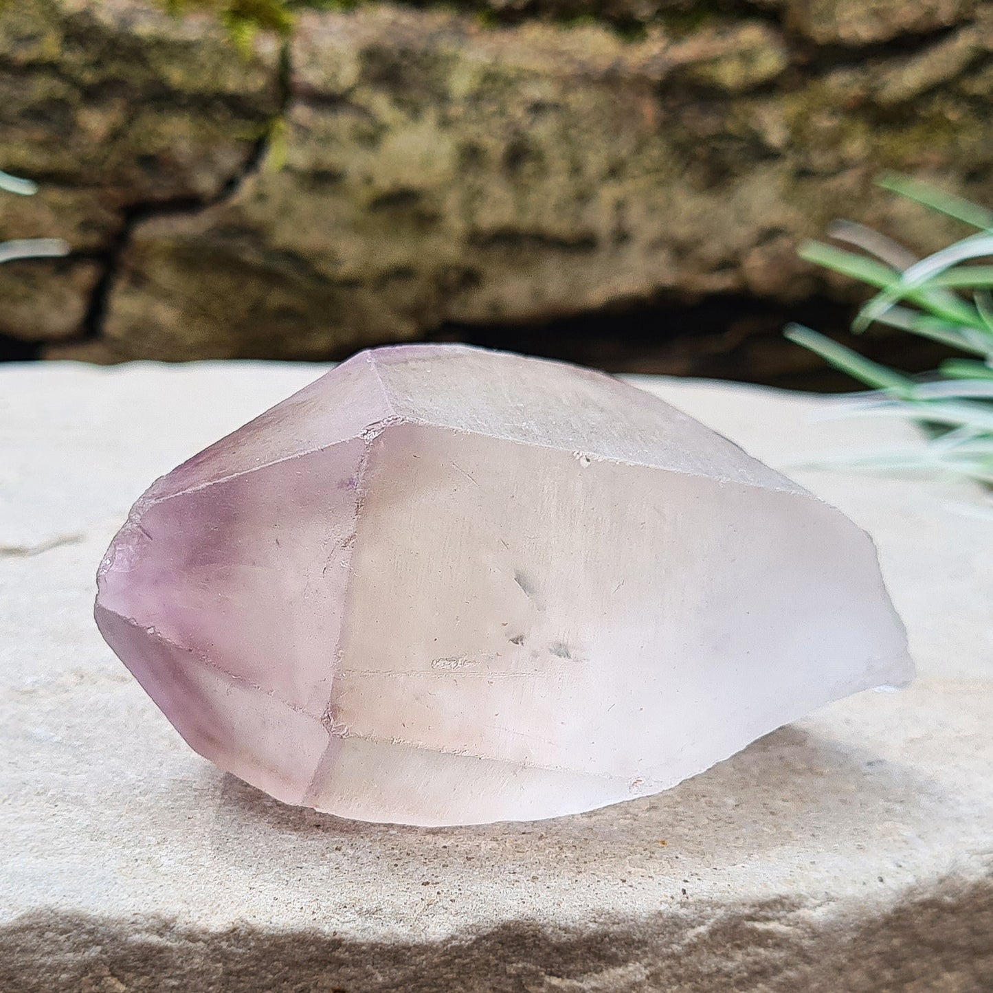 Madagascan Amethyst and Quartz Point. Natural. Once face has an Isis face, Madagascan Amethyst and Quartz have a very different feel and energy to the Quartz and Amethyst that comes out of anywhere else. This crystal is just gorgeous. It has a smokiness in the tip to it as well.