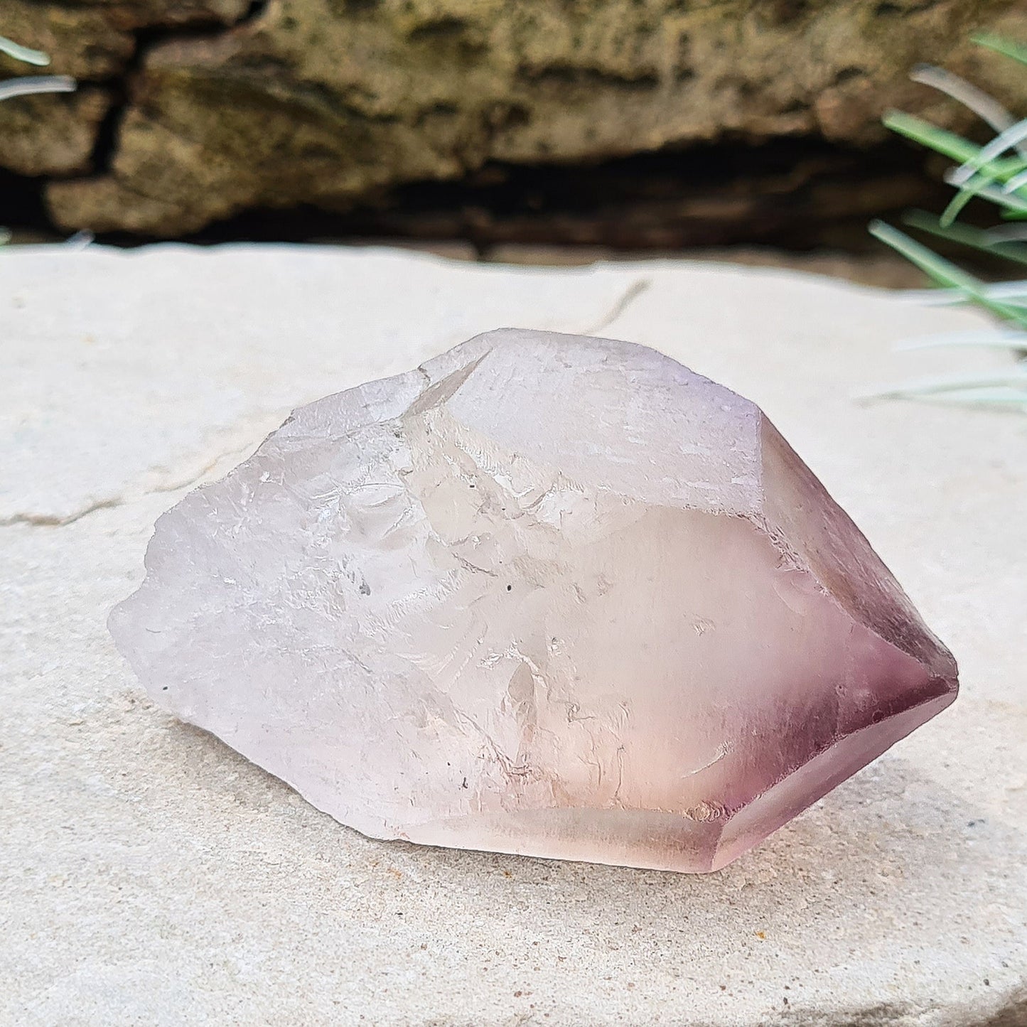 Madagascan Amethyst and Quartz Point. Natural. Once face has an Isis face, Madagascan Amethyst and Quartz have a very different feel and energy to the Quartz and Amethyst that comes out of anywhere else. This crystal is just gorgeous. It has a smokiness in the tip to it as well.