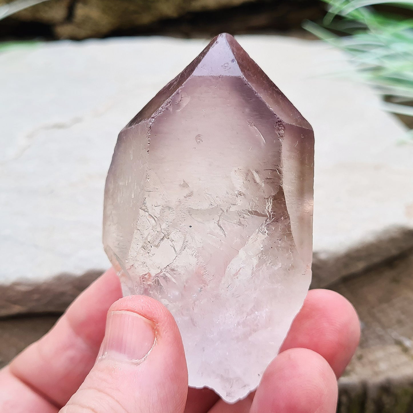 Madagascan Amethyst and Quartz Point. Natural. Once face has an Isis face, Madagascan Amethyst and Quartz have a very different feel and energy to the Quartz and Amethyst that comes out of anywhere else. This crystal is just gorgeous. It has a smokiness in the tip to it as well.