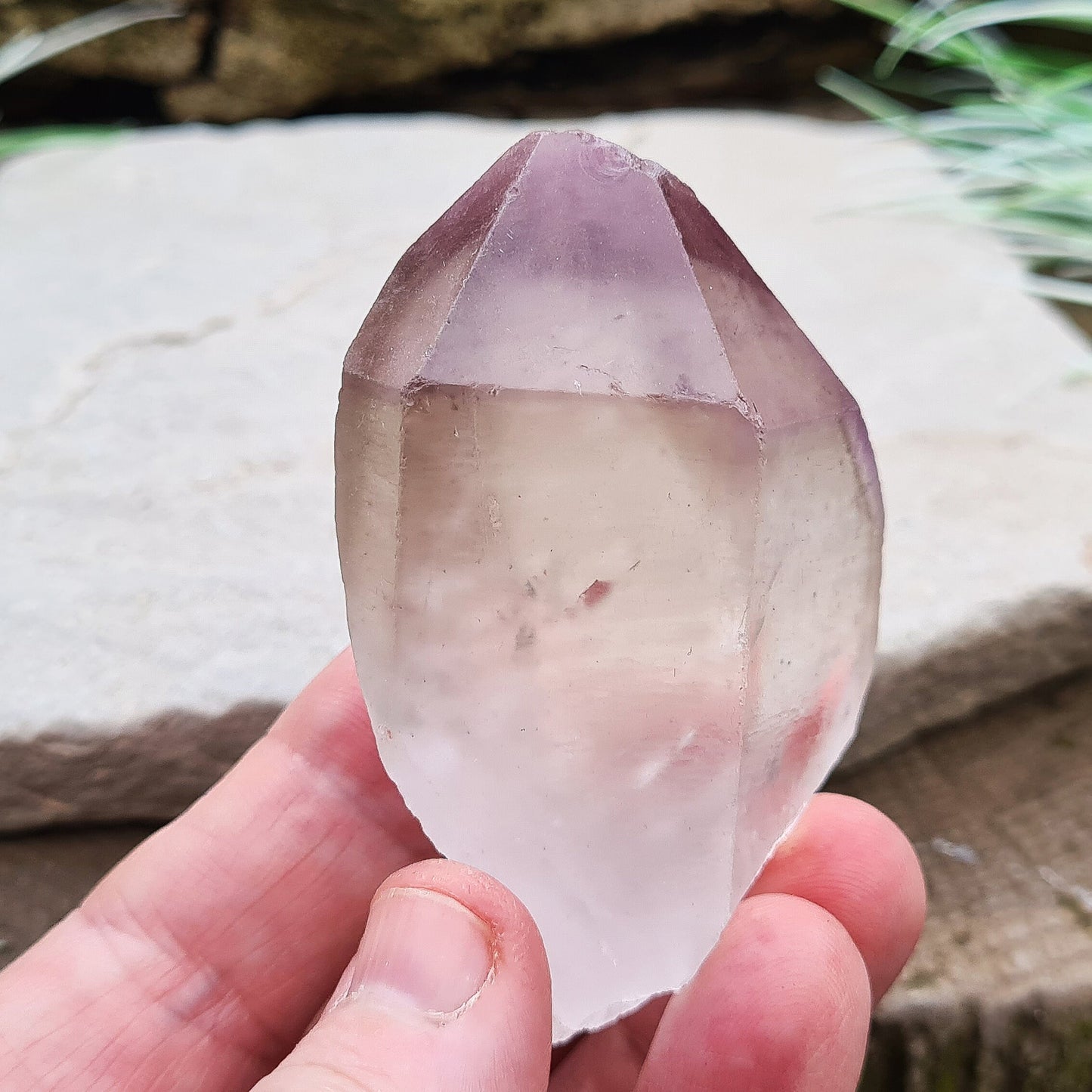 Madagascan Amethyst and Quartz Point. Natural. Once face has an Isis face, Madagascan Amethyst and Quartz have a very different feel and energy to the Quartz and Amethyst that comes out of anywhere else. This crystal is just gorgeous. It has a smokiness in the tip to it as well.