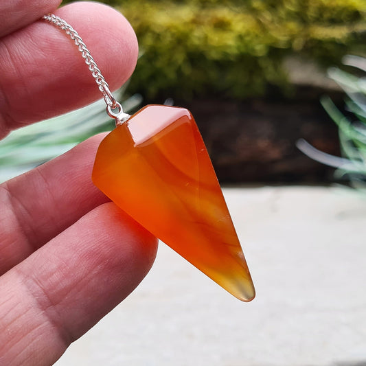 Carnelian Crystal Pendulum. From Madagascar. This pendulum has great orange colouring, and it has a druzy pocket towards the tip which is really unusual. 