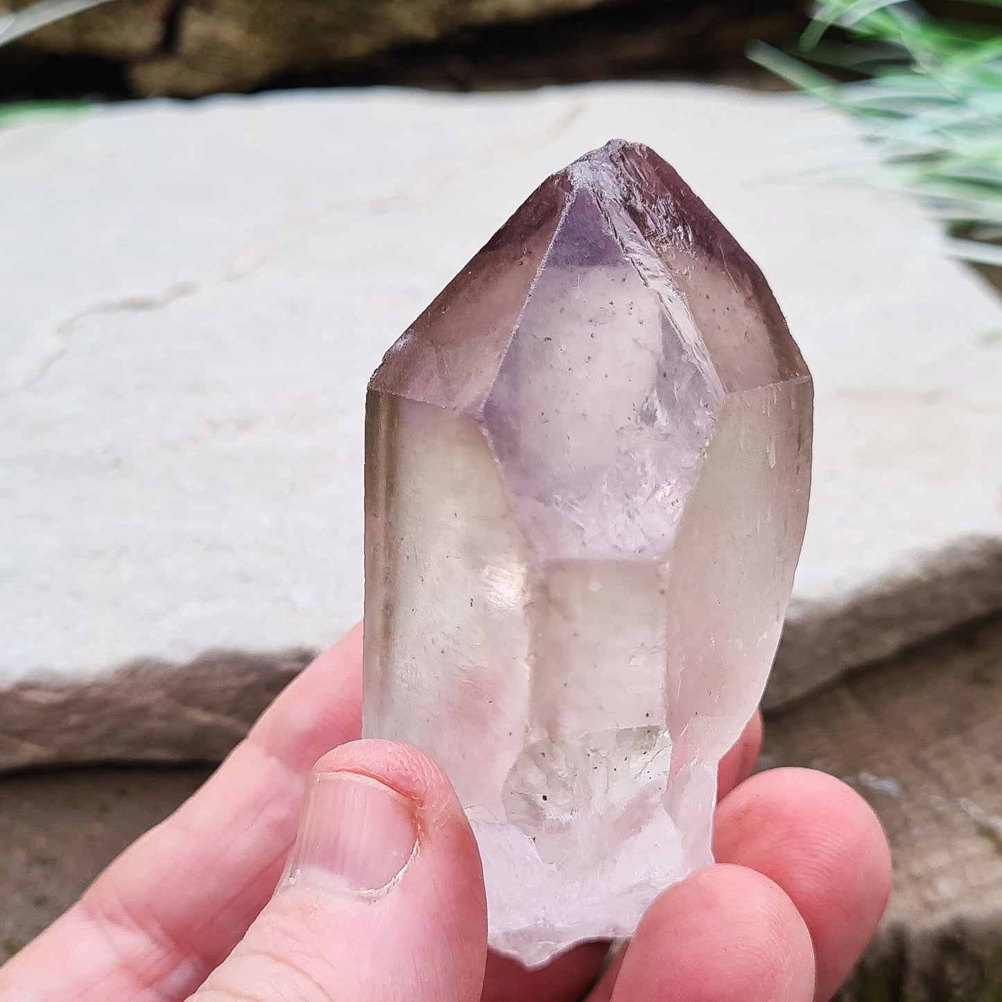 Madagascan Amethyst and Quartz Point. Natural. Once face has an Isis face, Madagascan Amethyst and Quartz have a very different feel and energy to the Quartz and Amethyst that comes out of anywhere else. This crystal is just gorgeous. It has a smokiness in the tip to it as well.