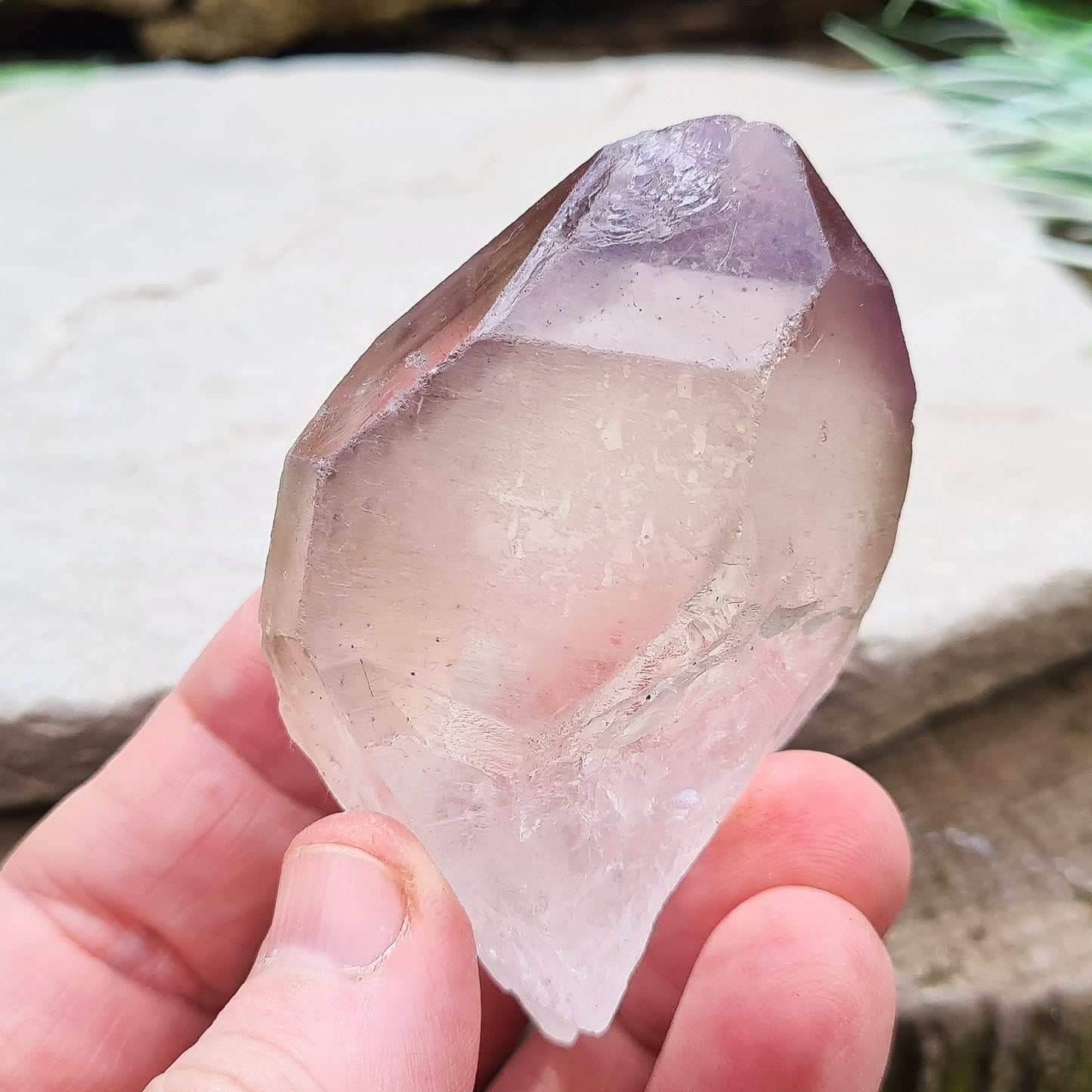 Madagascan Amethyst and Quartz Point. Natural. Once face has an Isis face, Madagascan Amethyst and Quartz have a very different feel and energy to the Quartz and Amethyst that comes out of anywhere else. This crystal is just gorgeous. It has a smokiness in the tip to it as well.