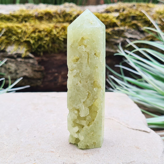 Prehnite Crystal Tower, point is a 6 sided Generator, has lovely natural cavities so you can see the crystalline structure within it. 