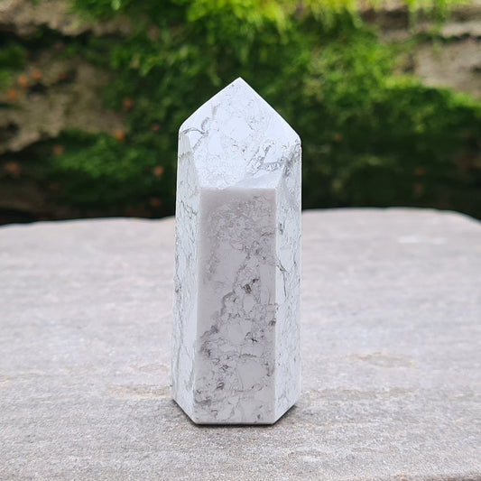 Howlite Point. Off White with grey marble like patterning, nicely polished. High grade.