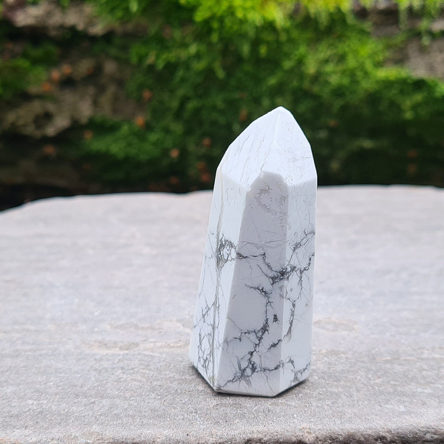 Howlite Point. Off White with grey marble like patterning, nicely polished. High grade.