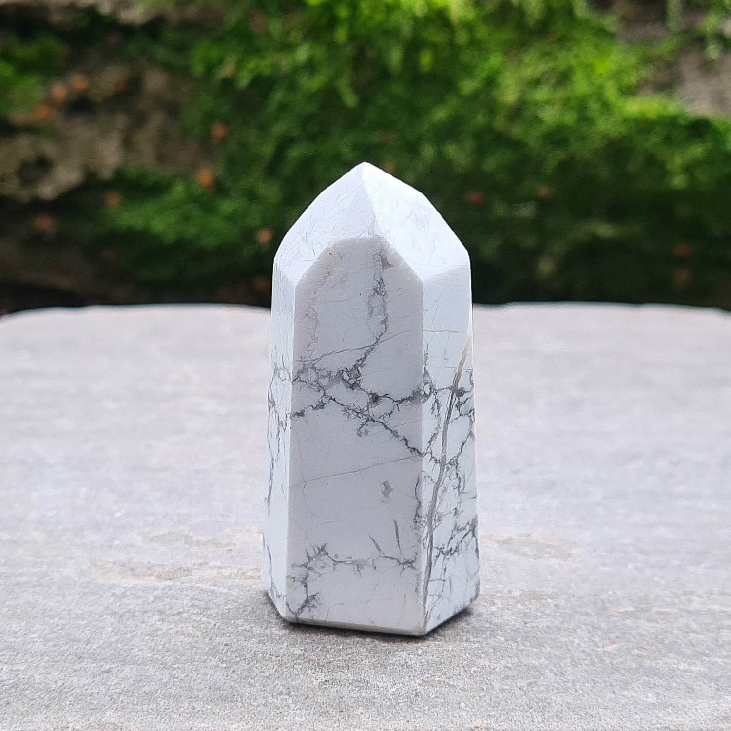 Howlite Point. Off White with grey marble like patterning, nicely polished. High grade.