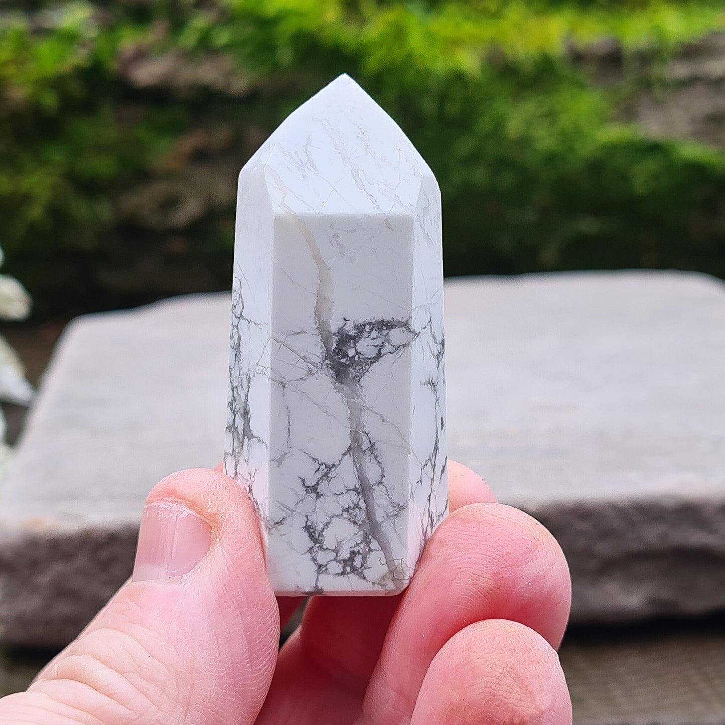 Howlite Point. Off White with grey marble like patterning, nicely polished. High grade.