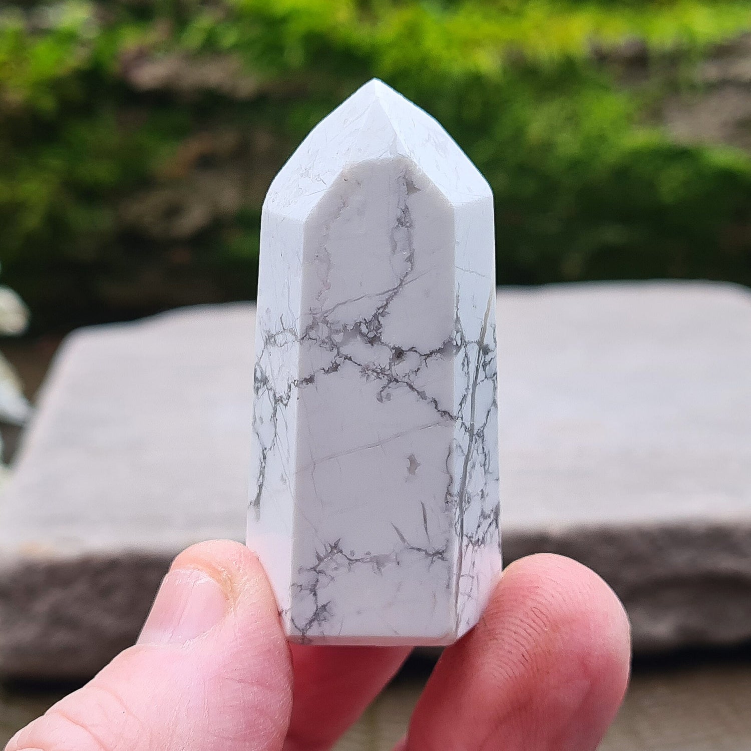 Howlite Point. Off White with grey marble like patterning, nicely polished. High grade.