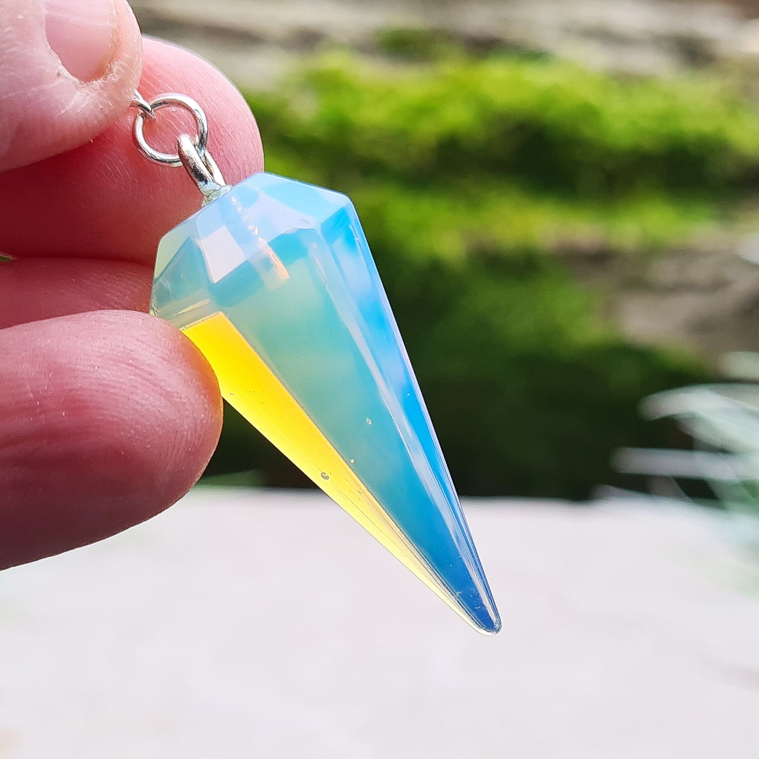 Opalite Crystal Pendulum, at end of the chain is a silver ring. All pendulums will come with a box or organza pouch to keep it in.