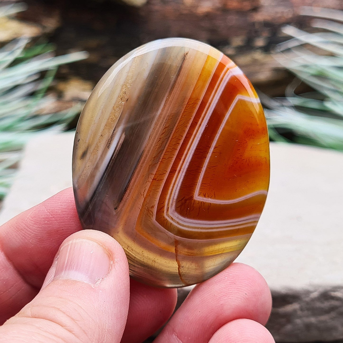 Carnelian and Agate Crystal Palm Stone. From Madagascar. This palm stone has a wonderful orange and grey banded colouring.