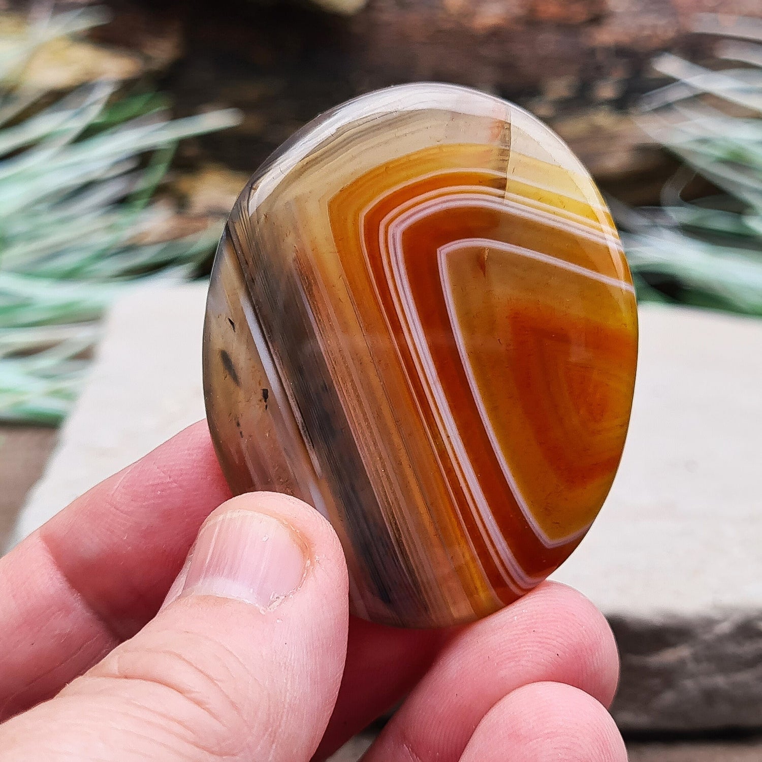 Carnelian and Agate Crystal Palm Stone. From Madagascar. This palm stone has a wonderful orange and grey banded colouring.