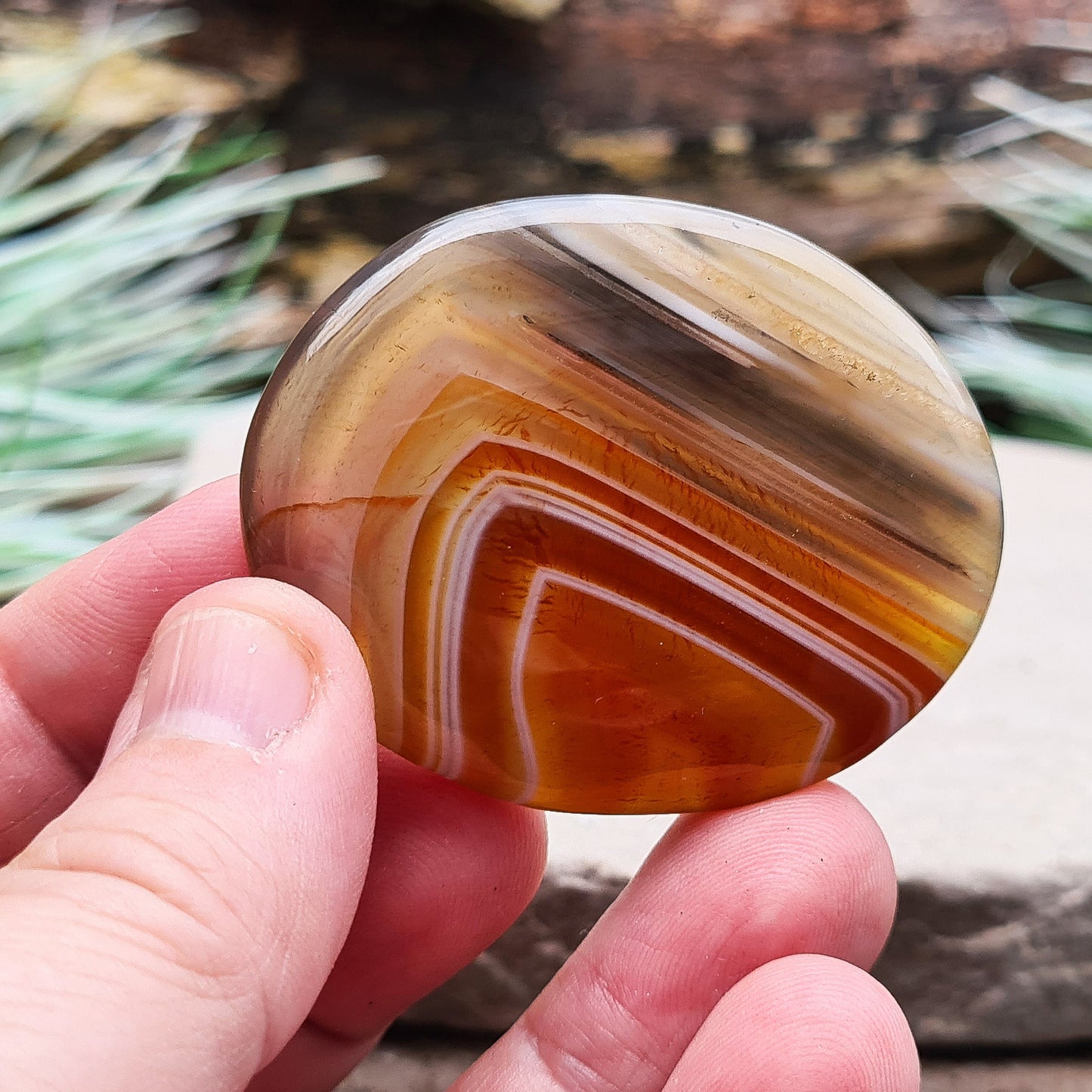 Carnelian and Agate Crystal Palm Stone. From Madagascar. This palm stone has a wonderful orange and grey banded colouring.