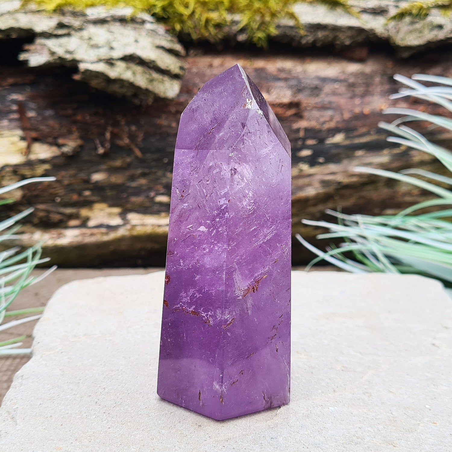 Amethyst Tower from Brazil. This polished crystal has great purple colouring. Faces are 7,3,7,3,7,3 sides. Some Iron Ore mineral inclusions.