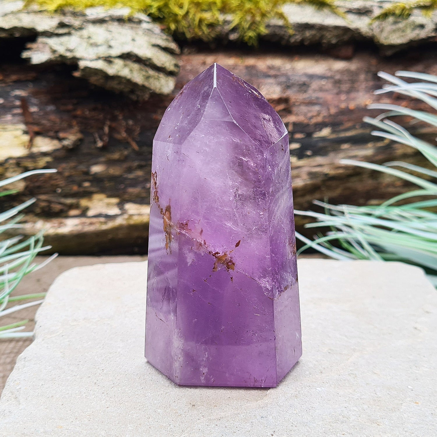 Amethyst Tower from Brazil. This polished crystal has great purple colouring. Faces are 7,3,7,3,7,3 sides. Some Iron Ore mineral inclusions.