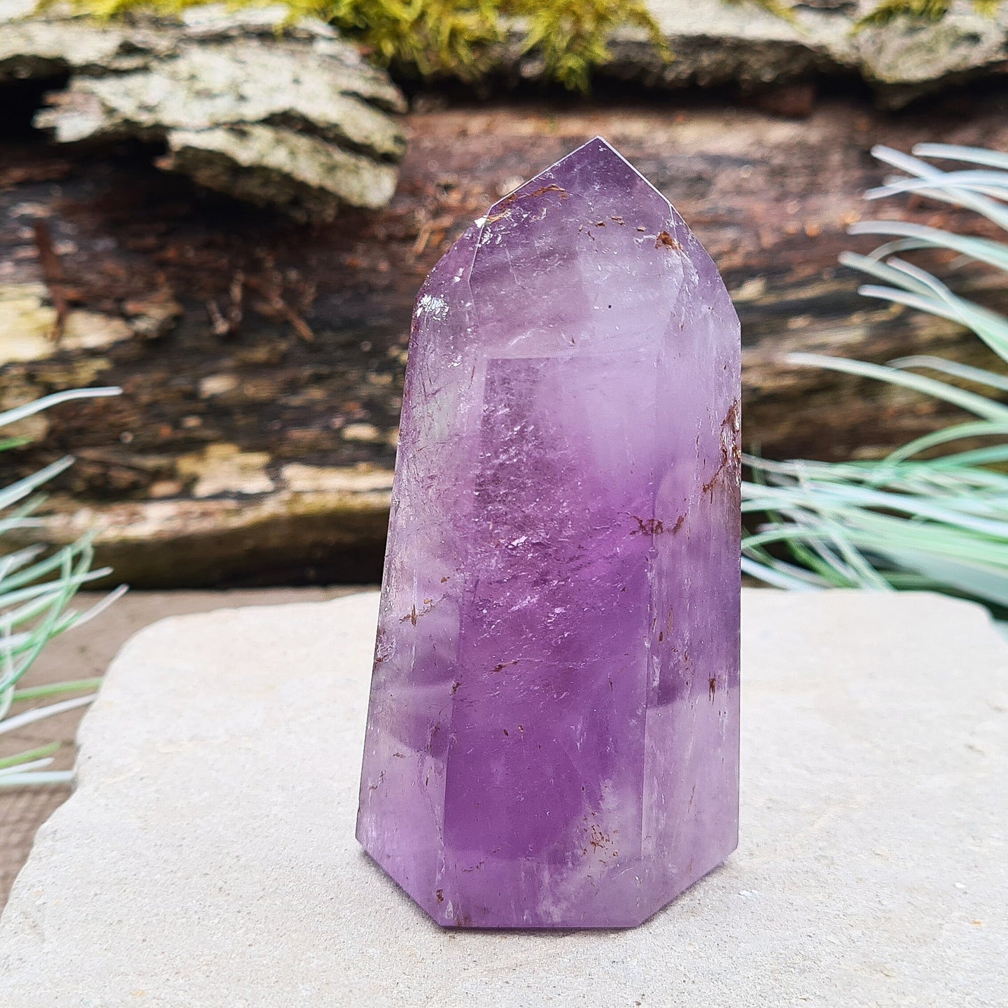 Amethyst Tower from Brazil. This polished crystal has great purple colouring. Faces are 7,3,7,3,7,3 sides. Some Iron Ore mineral inclusions.