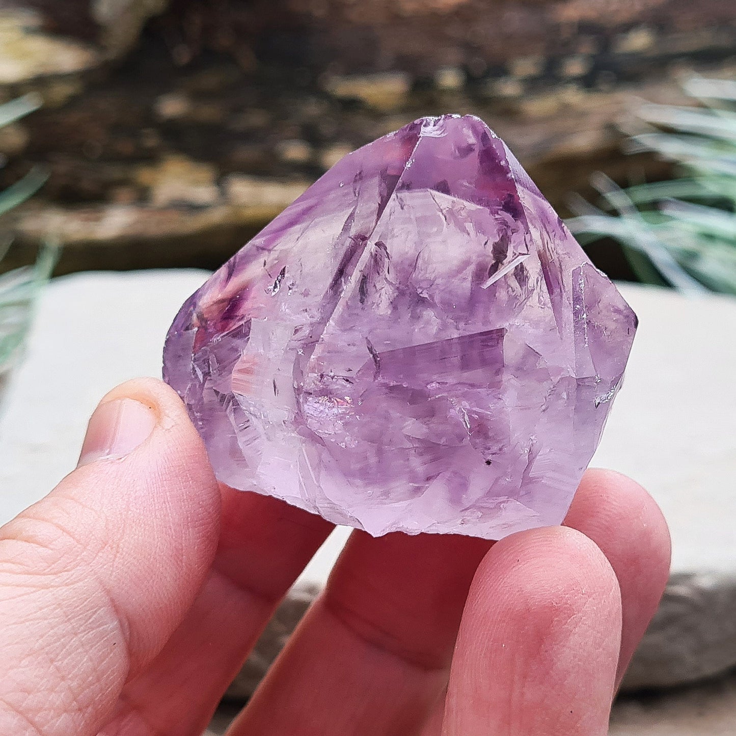 Amethyst crystal standing point from Brazil with a polished tip and a flat cut base. Features beautiful translucent purple coloring, while the remaining surface is left natural.