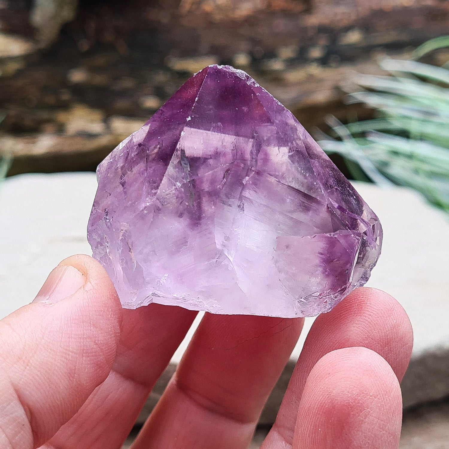 Amethyst crystal standing point from Brazil with a polished tip and a flat cut base. Features beautiful translucent purple coloring, while the remaining surface is left natural.