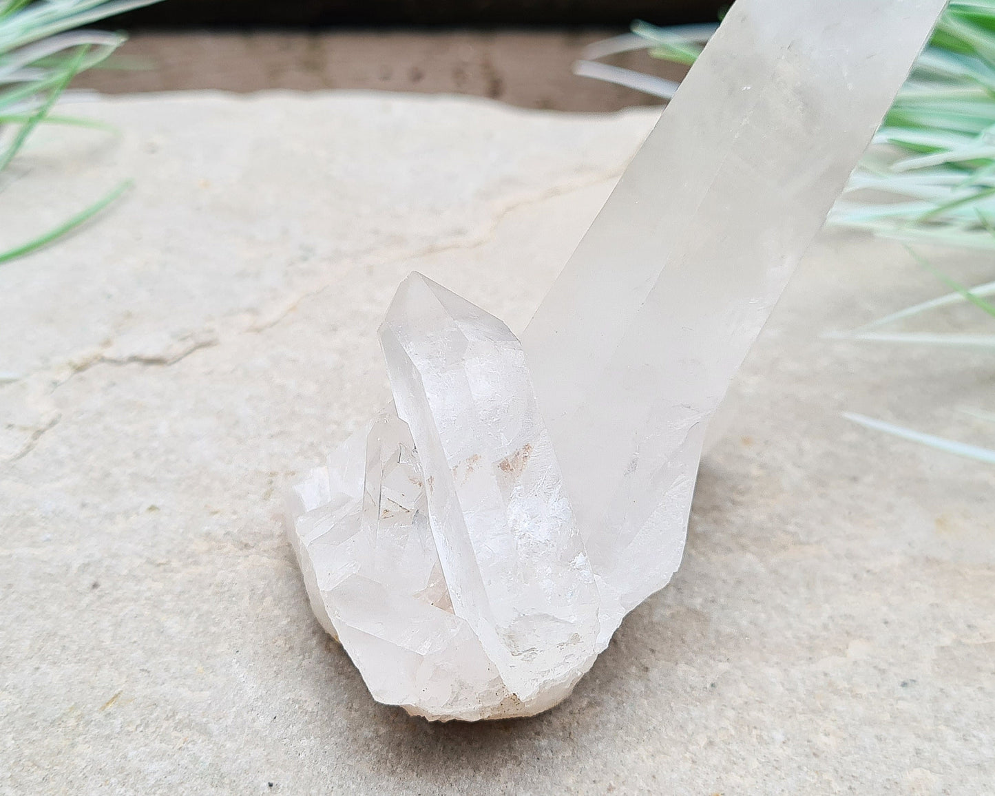 Madagascan Quartz Crystal Cluster with 1 large point and a couple of smaller points at its base. It will self stand.