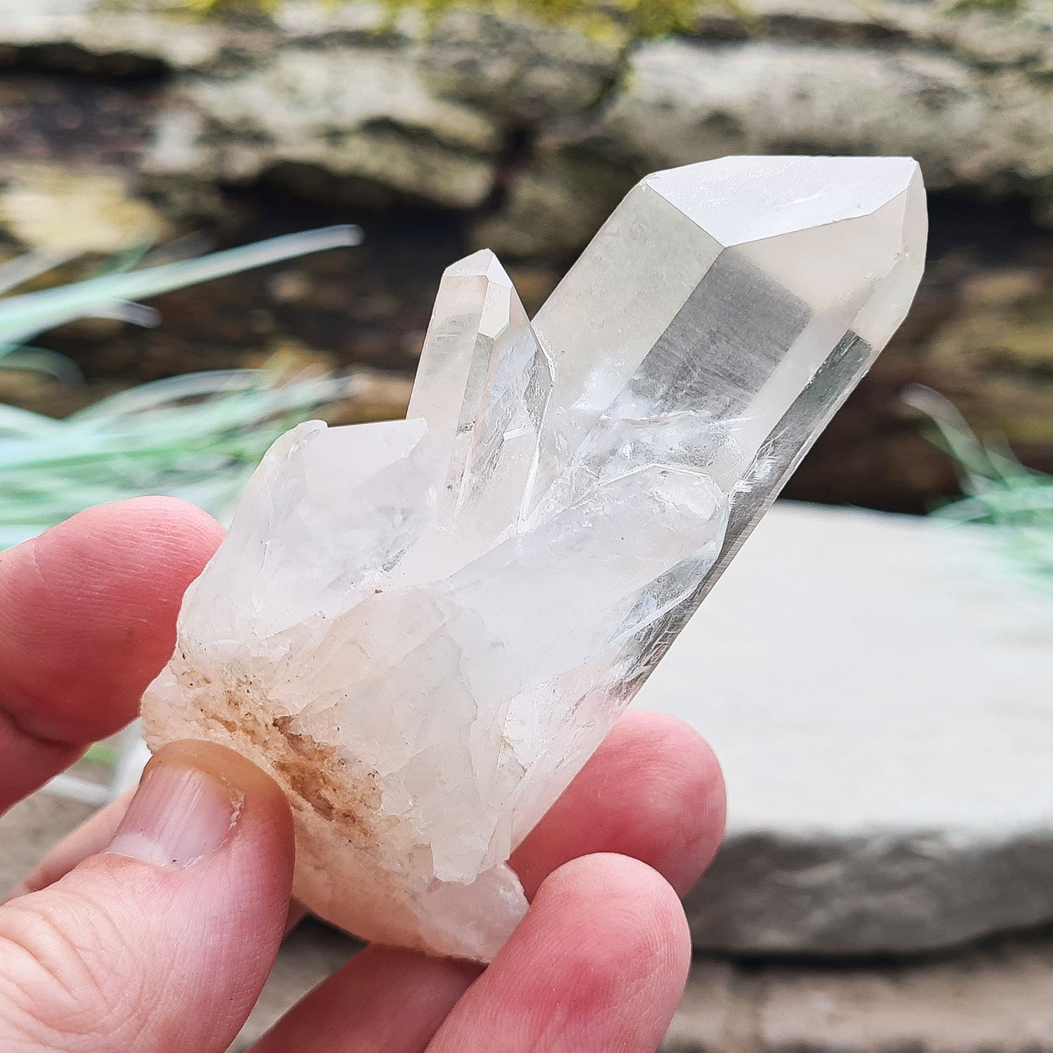 Madagascan Quartz Crystal Cluster with 1 large point and a few smaller points at its base.