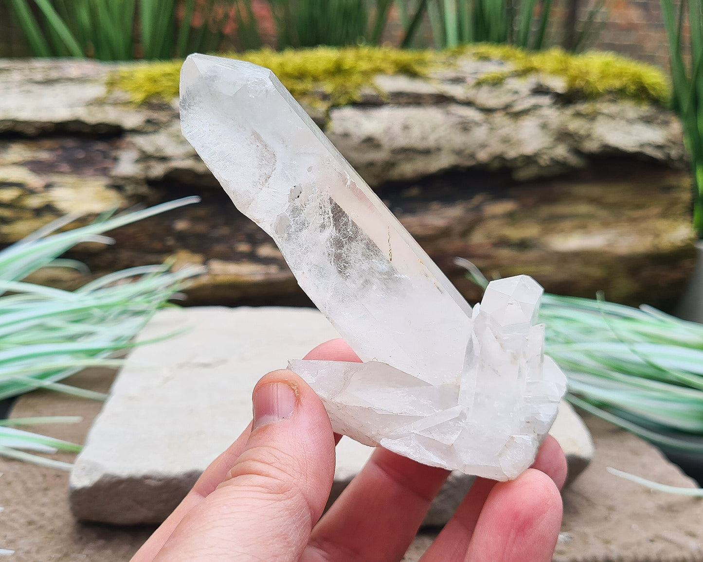 Madagascan Quartz Crystal Cluster with 1 large point and a couple of smaller points at its base. It will self stand.