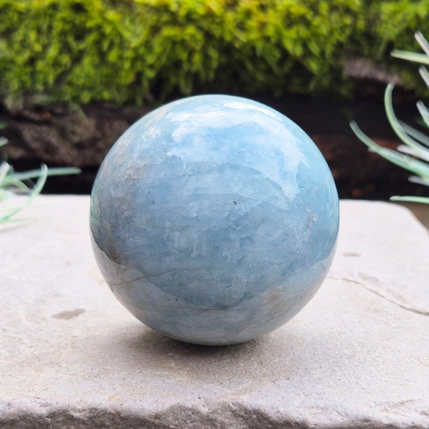 This aquamarine crystal sphere features a lovely pale aqua blue color with inclusions.