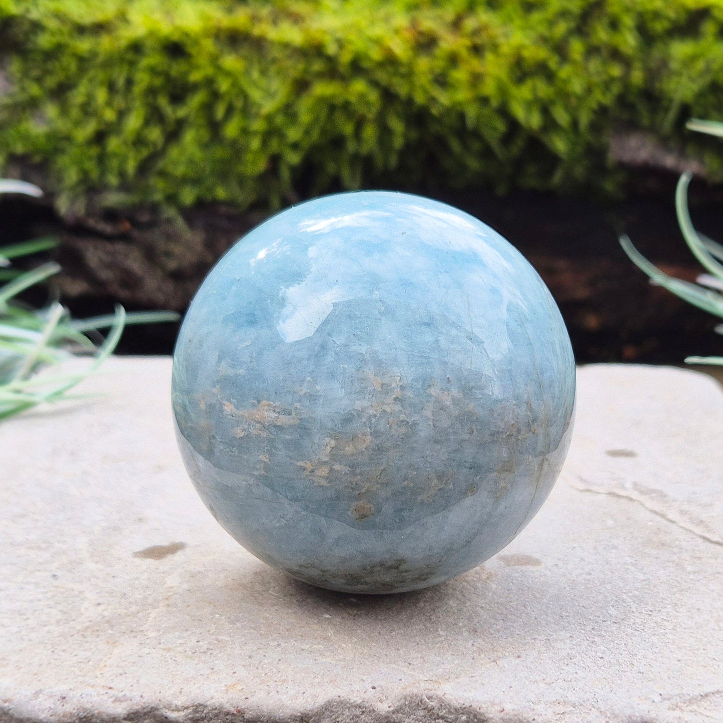 This aquamarine crystal sphere features a lovely pale aqua blue color with inclusions.