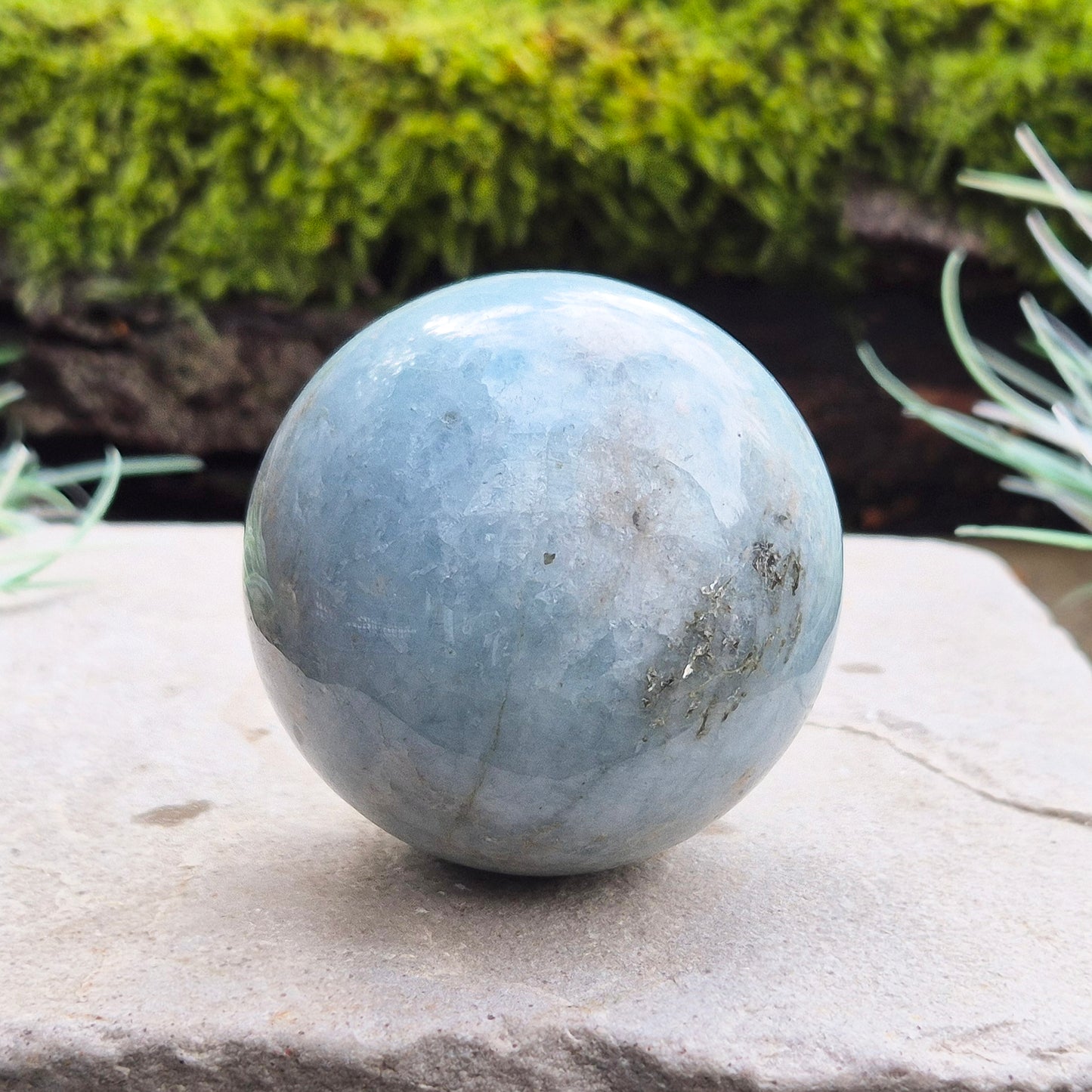 This aquamarine crystal sphere features a lovely pale aqua blue color with inclusions.