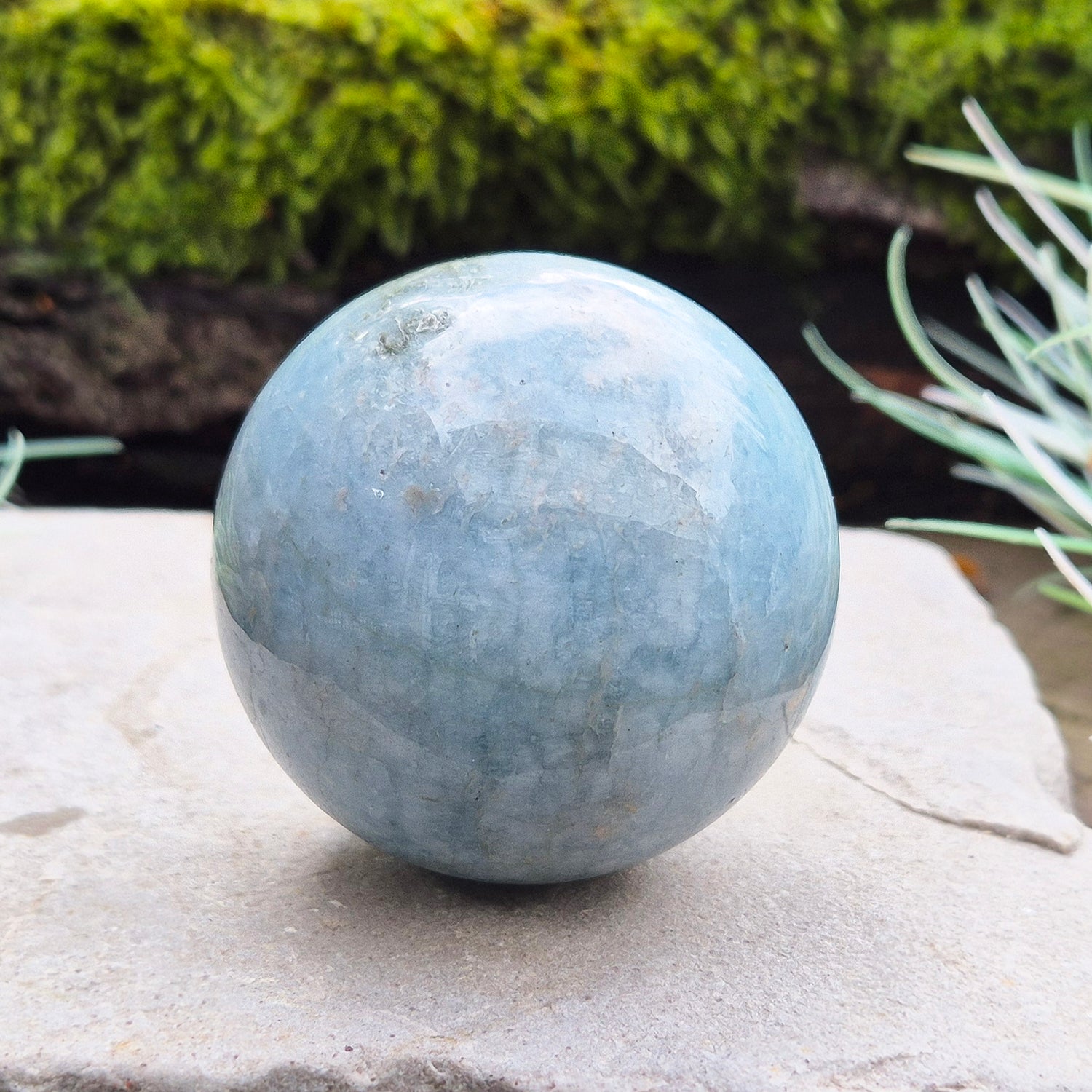 This aquamarine crystal sphere features a lovely pale aqua blue color with inclusions.