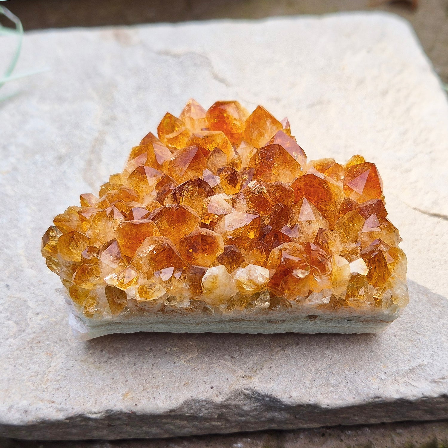 Citrine Crystal Cluster, Natural. From Brazil. Wonderful mid tone orange points on an even base which is even enough to sit on a flat surface.