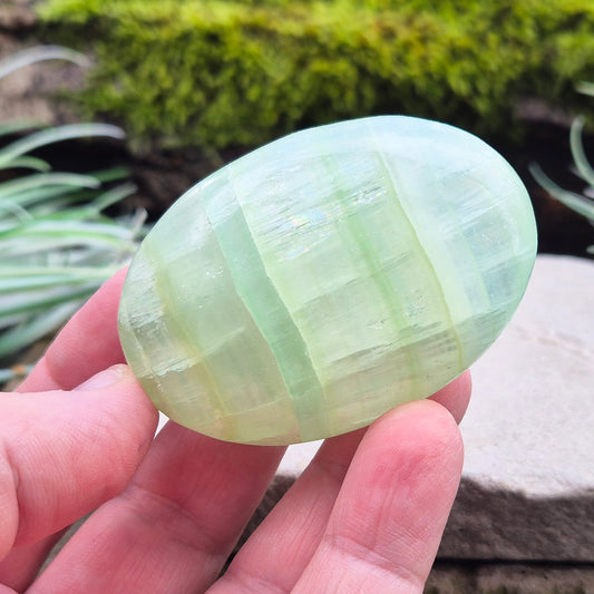 Pistachio Calcite Crystal Palm Stone. From the Khyber Pakhtunkhwa province of Pakistan. Pistachio Calcite is a pale green to pistachio colour variety of Green Calcite