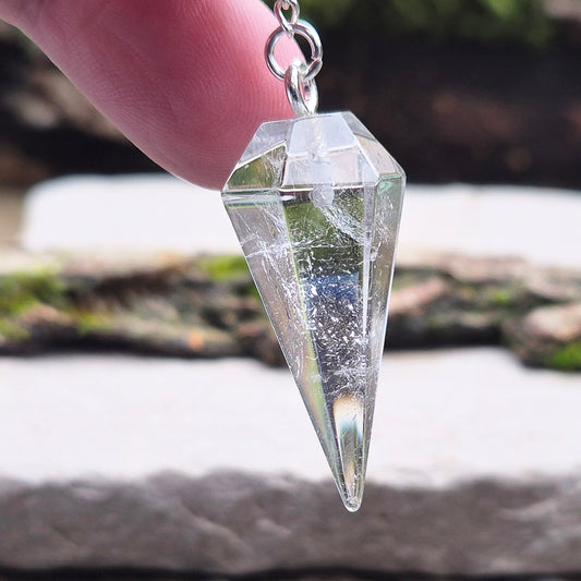 Clear Quartz Crystal Pendulum for dowsing and energy work. Comes in a box or pouch for easy storage. The chain features a silver ring for a comfortable grip.