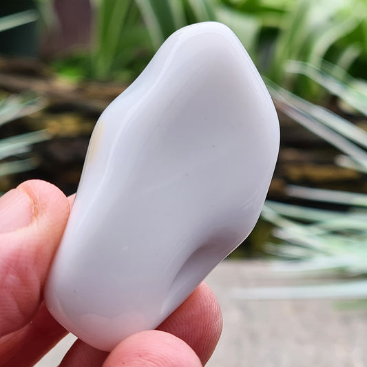 Smooth, milky-white Bohemian Cacholong Opal from the Czech Republic with a soft, pearly sheen, valued for its calming energy and rarity. Its creamy color with hints of gray promotes serenity, balance, and emotional healing.