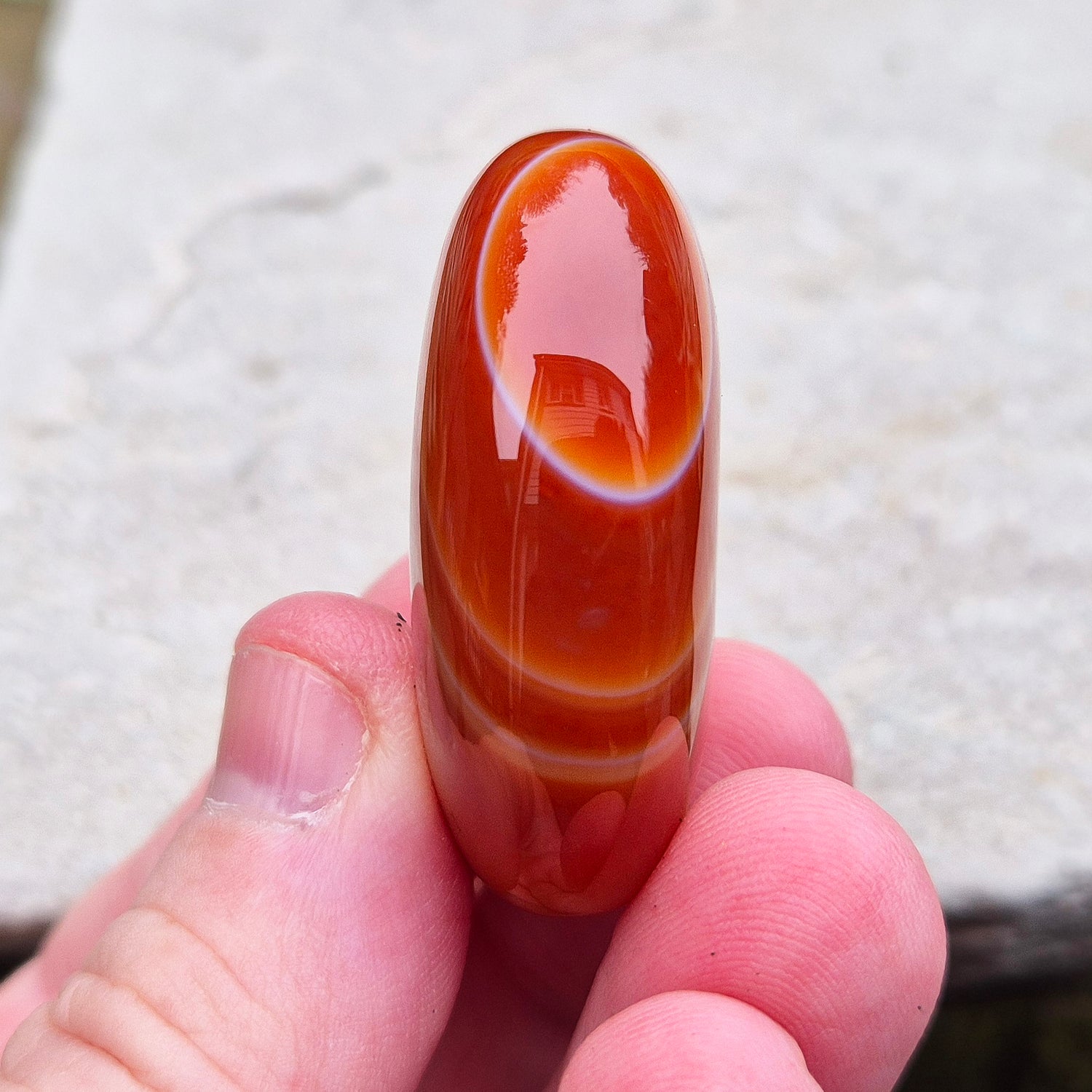 Carnelian Crystal Palm Stone. From Madagascar. This palm stone has a wonderful orange colour and some banding.