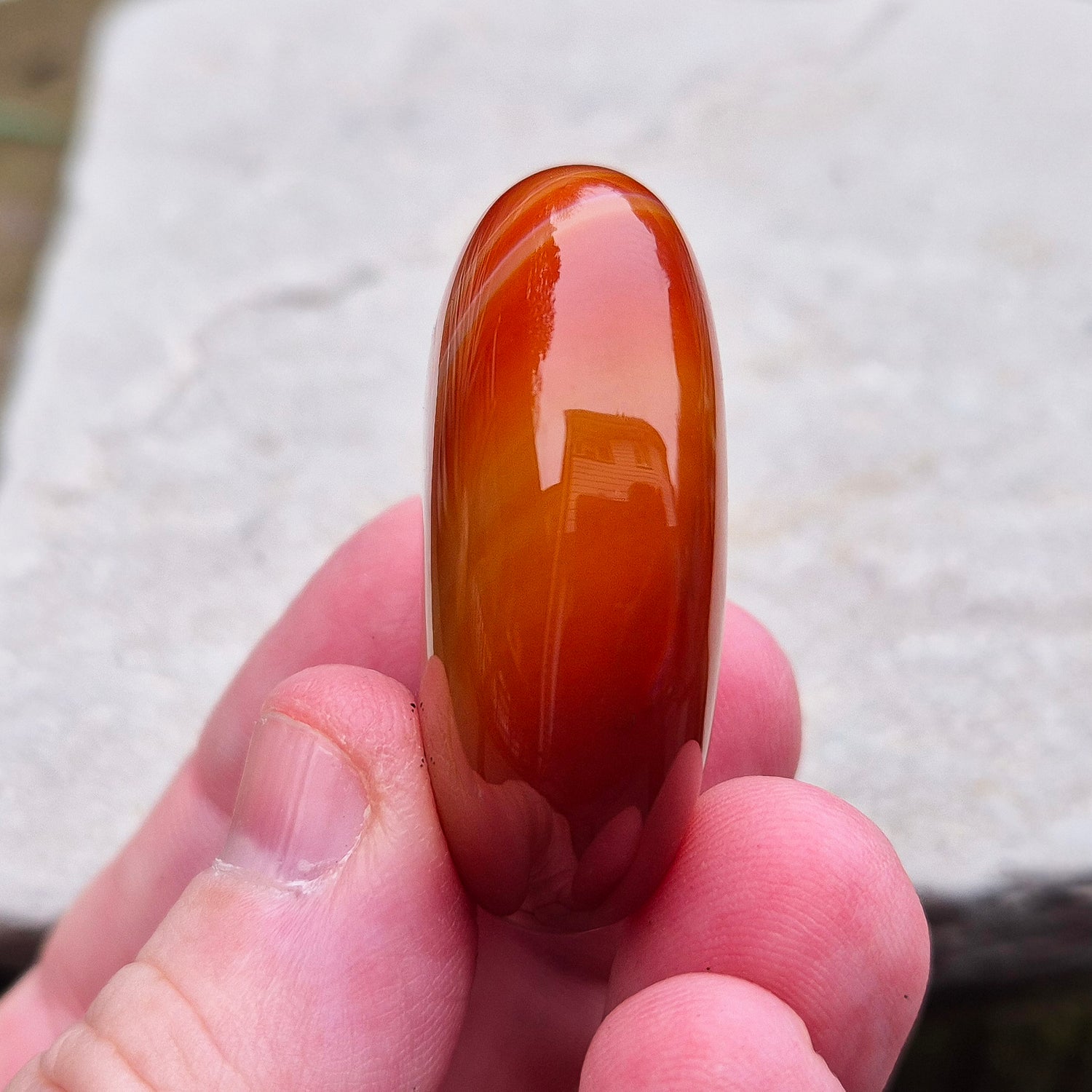 Carnelian Crystal Palm Stone. From Madagascar. This palm stone has a wonderful orange colour and some banding.