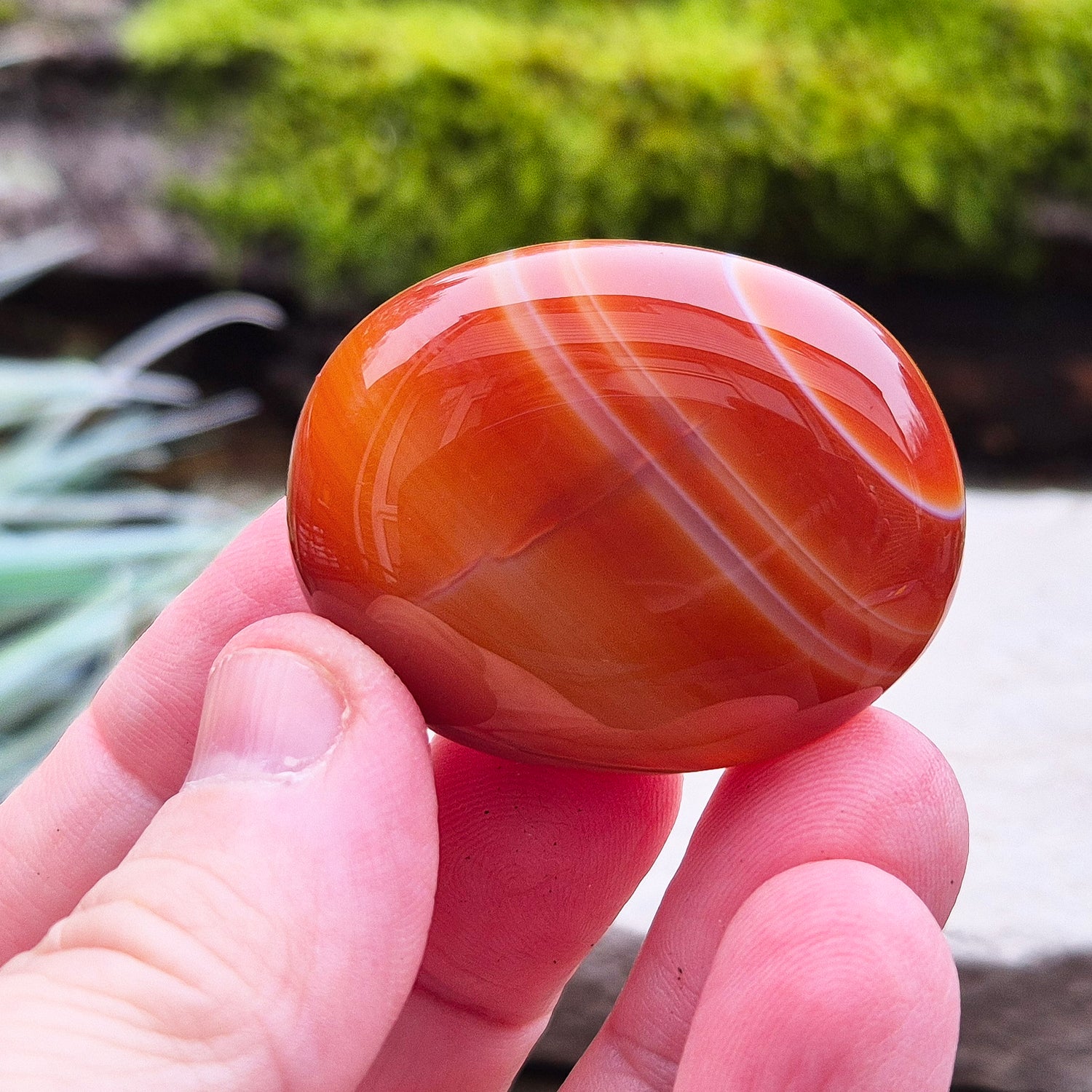 Carnelian Crystal Palm Stone. From Madagascar. This palm stone has a wonderful orange colour and some banding.