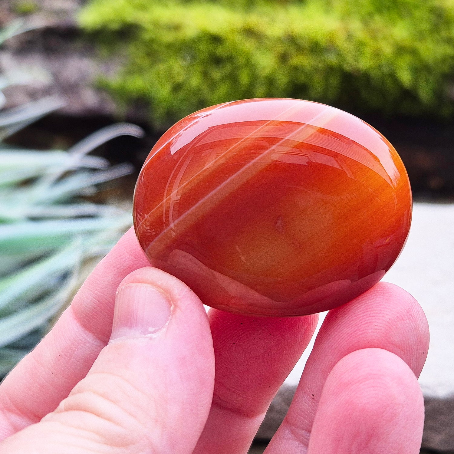 Carnelian Crystal Palm Stone. From Madagascar. This palm stone has a wonderful orange colour and some banding.