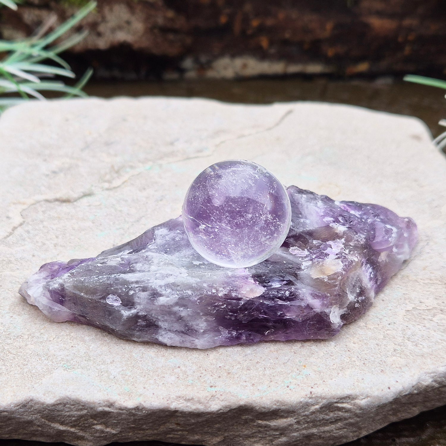 Chevron Amethyst Crystal Platform. One side is left untouched in its raw form, while the other is cut flat to create a versatile platform for displaying crystals,